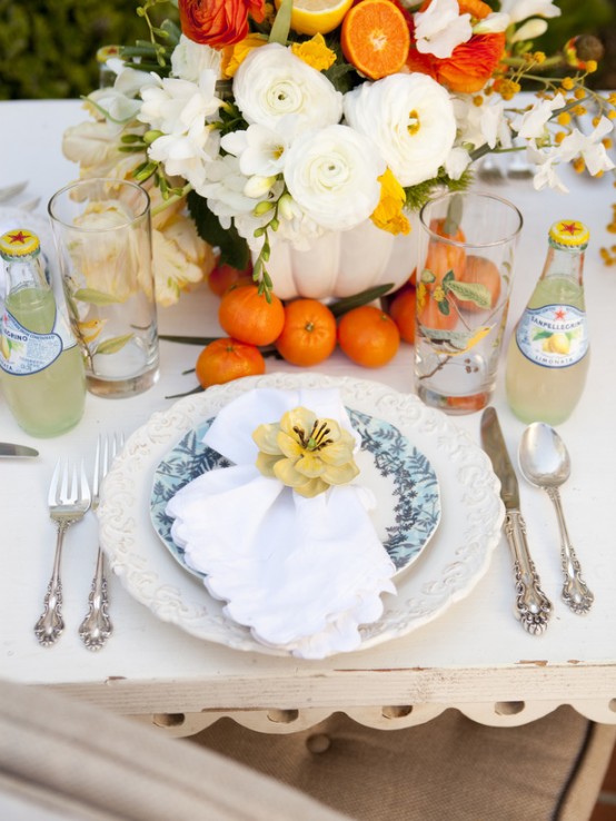 elegant white and blue patterned porcelain and bright blooms and fruit are a lovely idea for a Mother's Day tablescape