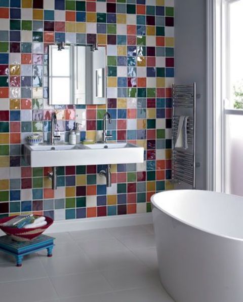 a modern white bathroom with an accent wall clad with super bright and bold tiles and with all white everything looks cool and cheerful