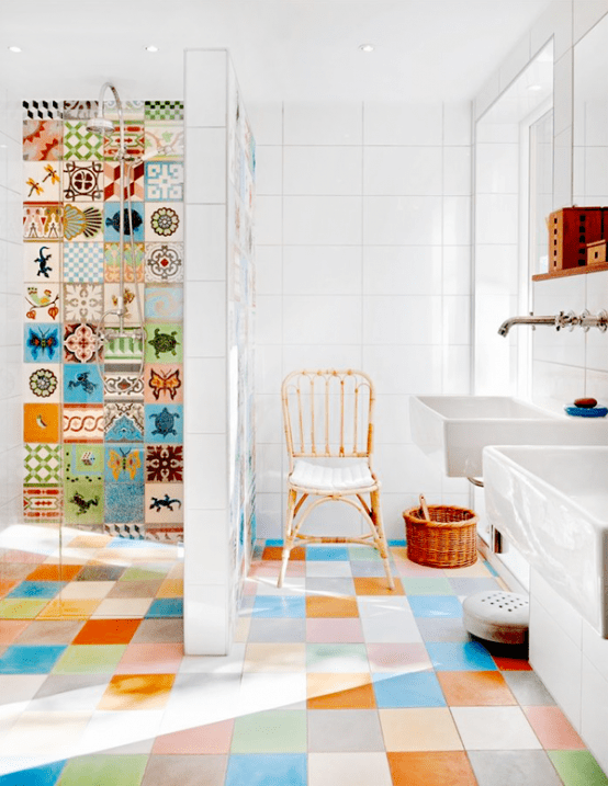 a bright multi-color tiled bathroom with just colorful and printed tiles in the shower, with white appliances to create a balance