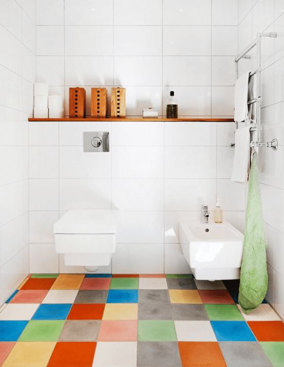 a contemporary bathroom done in white, with a super colorful tile floor that adds a cheerful feel to the space and makes it fun