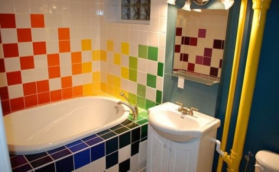 a white bathroom with a navy accent wall and with super bright tiles for an accent is a creative idea for a kid's space
