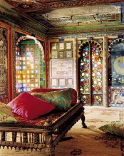 a super colorful Moroccan bedroom with lots of pattern, a beautiful ceiling, colorful pillows and rugs