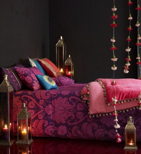 bright printed bedding, Moroccan lanterns with candles and colorful floral garlands for a peaceful yet bold space