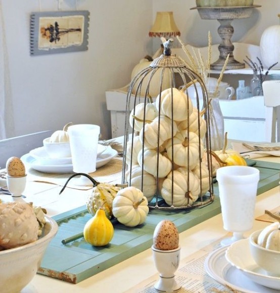 white pumpkins in a cage and gourds are great to style your Thanksgiving table and make it chic and cool