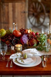 a luxurious harvest Thanksgiving centerpiece of various kinds of greenery, fresh vegetables and fruits is amazing and edible