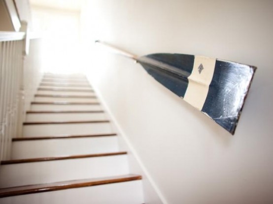 a white staircase with an oar rail is a lovely idea for a beach, coastal or seaside home