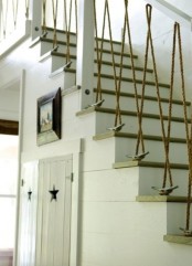 a nautical staircase with railing with rope and driftwood looks very whimsical and bold