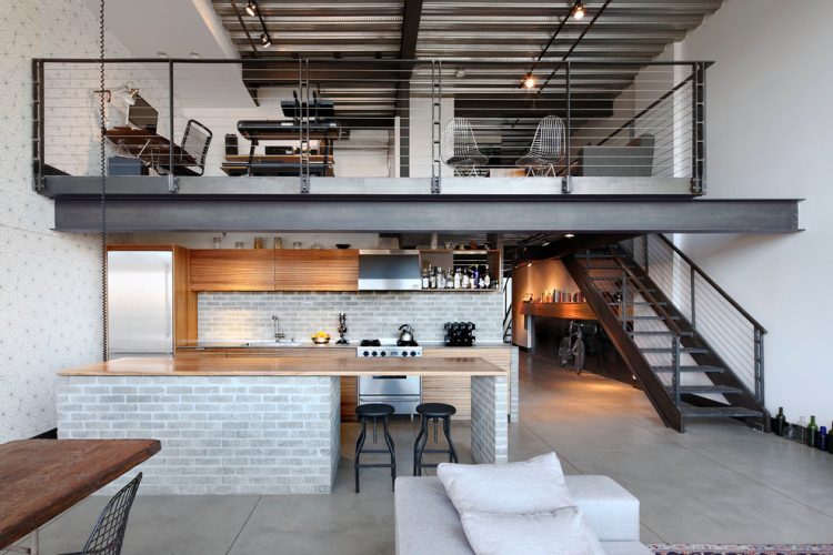open urban kitchen design with concrete floors and faux brick surfaces
