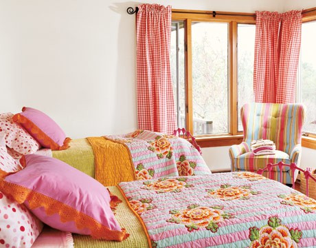 a shared neutral bedroom turned into a super bright one using bold textiles - curtains, pillows and blankets looks amazing