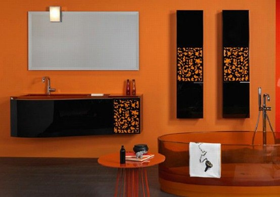 a unique bathroom done in orange and black, with an orange glass bathtub is an unbelievable idea of a bathing space