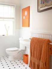 add bright orange touches with an artwork, a litter box and some towels – it’s easy to spruce up a neutral space with just some items