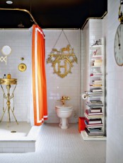 a whimsy art deco bathroom in black, white and gold and an orange curtain and litter box for a more modern and bright touch