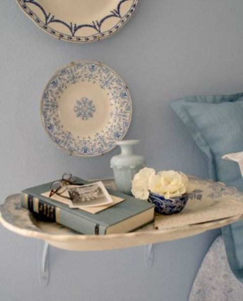 a large blue and white porcelain tray attached to the wall is a lovely idea to add a chic feel to the space and make it amazing