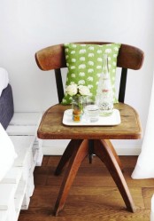 a stained wooden chair with a bright pillow is a beautiful idea of a nightstand, it feels very vintage-like