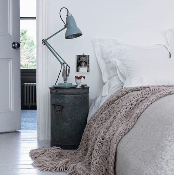 a dark metal nightstand with a blue metal table lamp is a chic idea for a Scandinavian bedroom and it will give a rustic feel to the space