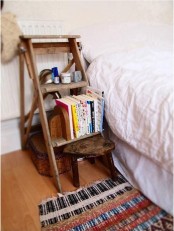 a vintage wooden staircase with books and a basket for storage under the stairs for a lovely and cool look
