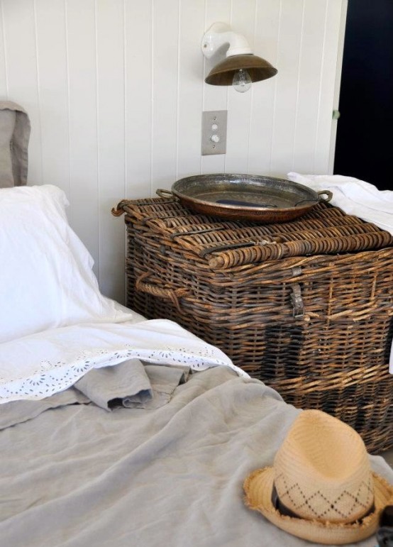a large woven chest with a lid is a creative and cool idea for storage and to use it as a nightstand is great for a rustic-inspired space