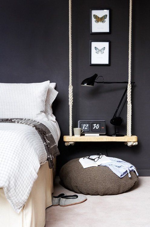 a rope and wood swing with a table lamp, a clock and a mug is a creative and cool idea for a Scandi bedroom