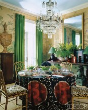 a bright Eastern dining space done in yellow, green and gold, bright textiles and a statement mirror