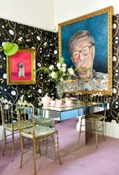 a whimsy colorful dining room with fun artworks, a mirror table and glam gold chairs