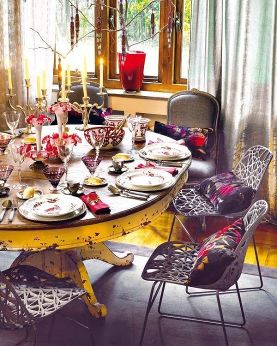 a colorful boho dining room with a shabby chic table, catchy chairs, candles and colorful vases and pots