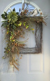 a square vine and twig wreath with greenery, foliage, faux blooms, berries and fruit for the fall