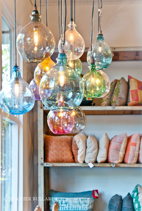 a cluster of colorful and pastel glass pendant lamps is a gorgeous solution for a kitchen, it will bring color and a touch of gloss to the space