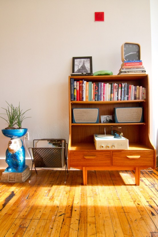 a funky bright wooden bookcase with open shelves and drawers features much storage space and adds color