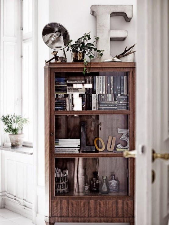 a mid-century modern wooden bookcase with glass covered compartments looks rather lightweight and you won't need to dust the shelves every time