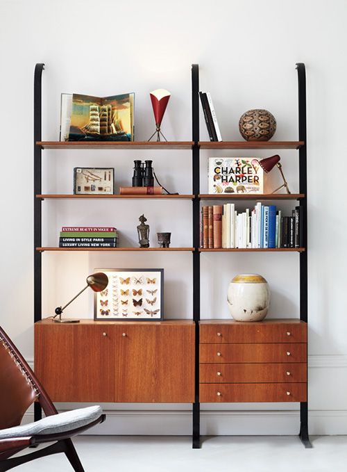 a mid-century modern bookcase of metal and rich-stained wooden shelves and drawers is a stylish idea that doesn't take any floor space