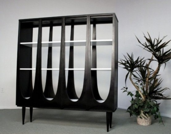 an unusual dark wood bookcase with curves and cutouts plus tall legs will make a statement