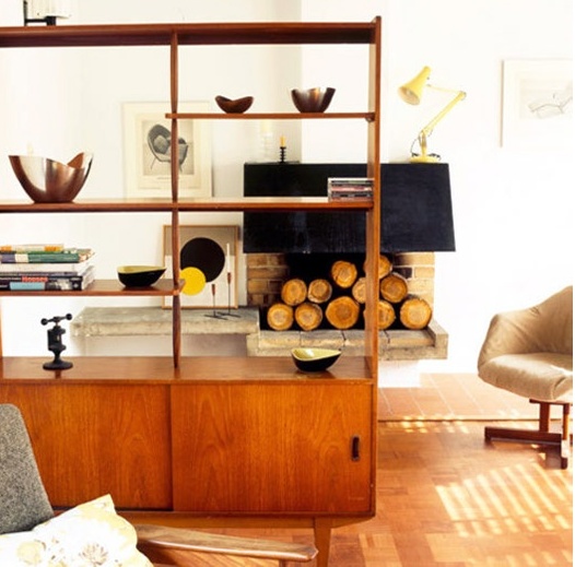 a bright shaded wooden mid-century modern bookcase with shelves and closed storage cabinets