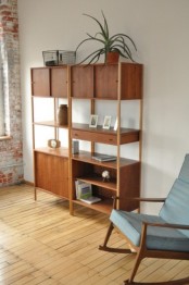 a rich-stained mid-century modern bookcase with closed cabinets, drawers and open shelving
