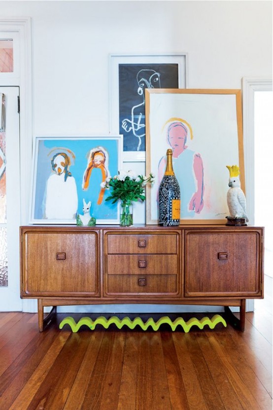a chic stained sideboard with wooden doors with knobs, drawers and carved touches is a lovely and chic idea
