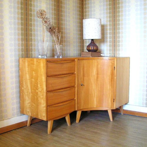 a curved light-stained mid-century modern sideboard with drawers and a door is a very catchy solution for a corner in your space