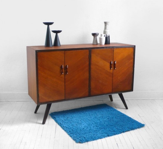 a super simple and cool rich-stained mid-century modern sideboard with doors, with black framing, handles and legs is a lovely idea for a modern space