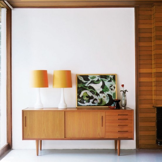 a light-stained amber-colored sideboards with doors and drawers on tall legs is a cool idea for a mid-century modern space
