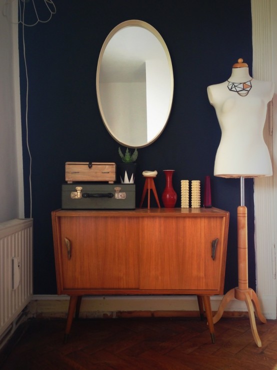 a small and cute mid-century modern sideboard with sliding doors with big handles and on tall legs is a lovely idea