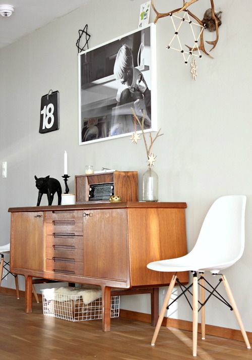 a super elegant light-stained sideboard with drawers and cutout handles and doors on tall legs is a lovely idea for a mid-century modern space