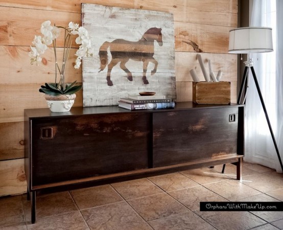 a dark-stained sideboard with sliding doors with cutout handles and on tall legs will make a statement in your space adding color and a contrasting touch if it's not dark