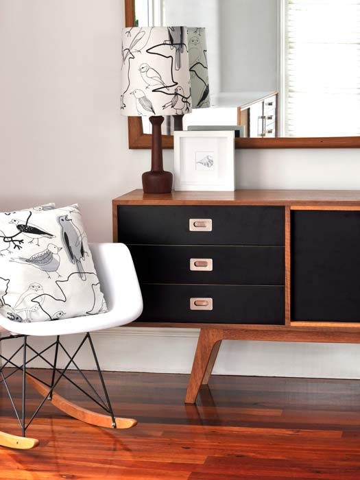 a beautiful mid-century modern sideboard with rich stained and black parts, doors and drawers is a lovely idea for adding retro chic to your space