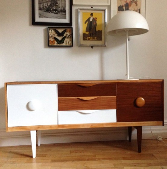 a beautiful mid-century modern sideboard with a white and a dark-stained door, three tiny drawers in white, light and dark stained and cool knobs