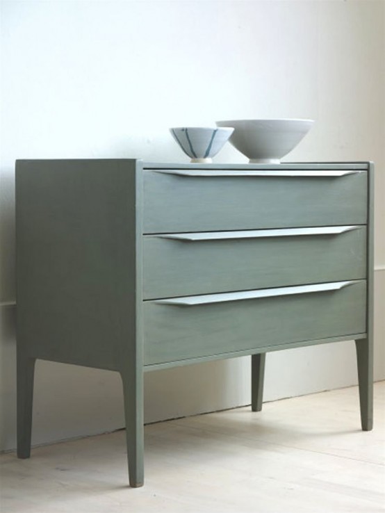 a laconic olive green mid-centurymodern sideboard with drawers and pulls on tall legs will be a nice idea for a Scandinavian interior