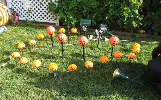 Turn simple orange tissue paper balls into jack-o-lanterns! Simply cut facial features and from black paper and apply to the balls.