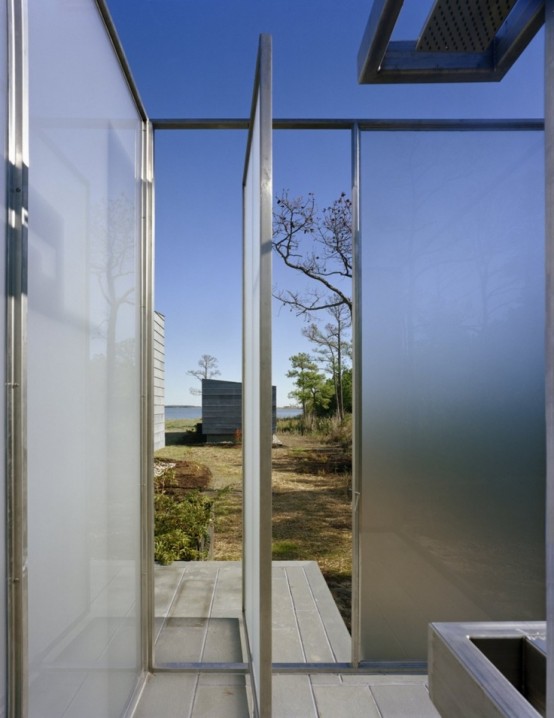 an ultra-modern outdoor shower completely done with frosted glass