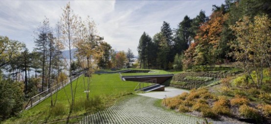 Partially Buried Lake House With Nature Let In