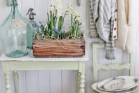 a wooden box with various bulbs and hay, a large bottle with branches for simple and chic natural spring decor