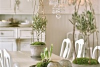 vintage Nordic decor with potted bulbs in moss, mercury glass candleholders, potted greenery with willow and moss