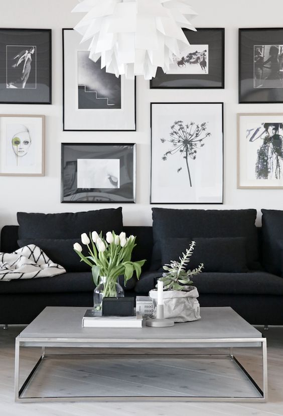 a sheer vase with white tulips, a wrapped planter with succulents and a candle for refreshing this bold black and white Nordic space