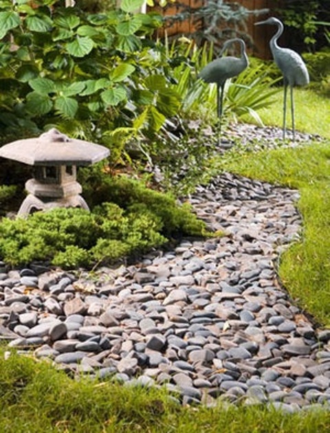 Stone lanterns shaped as pagodas are quite popular features of zen gardens. If you have a pavilion or a tea house their the lantern could be designed to remind its shape.